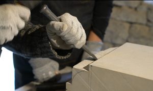 Stagiaire à l'œuvre pendant le stage de taille de pierre en Aveyron